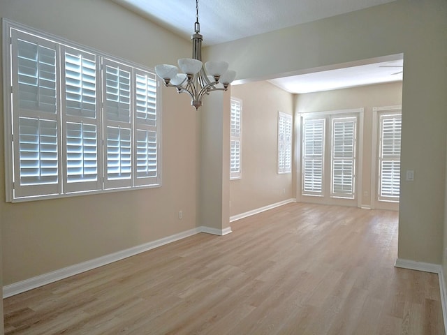 10902 SW Blue Mesa Way, Port Saint Lucie, FL 34987 - spare room featuring a chandelier and wood finished floors