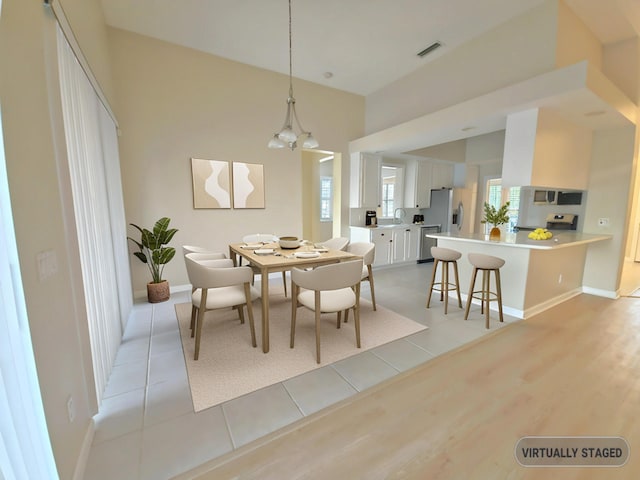 10902 SW Blue Mesa Way, Port Saint Lucie, FL 34987 - dining room with a chandelier and light wood-type flooring