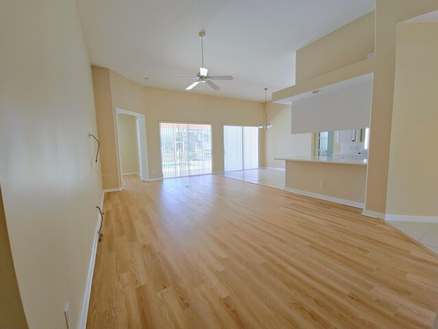 10902 SW Blue Mesa Way, Port Saint Lucie, FL 34987 - unfurnished living room featuring a ceiling fan and light wood-style flooring