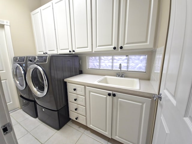 10902 SW Blue Mesa Way, Port Saint Lucie, FL 34987 - laundry room with cabinet space, light tile patterned floors, and washer and clothes dryer
