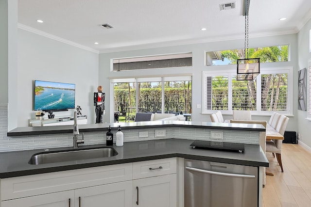 10740 Grande Blvd, West Palm Beach, FL 33412 - kitchen featuring crown molding, stainless steel dishwasher, a sink, dark countertops, and visible vents