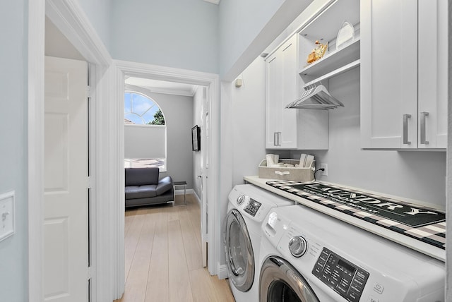 10740 Grande Blvd, West Palm Beach, FL 33412 - laundry room with baseboards, cabinet space, separate washer and dryer, and light wood finished floors
