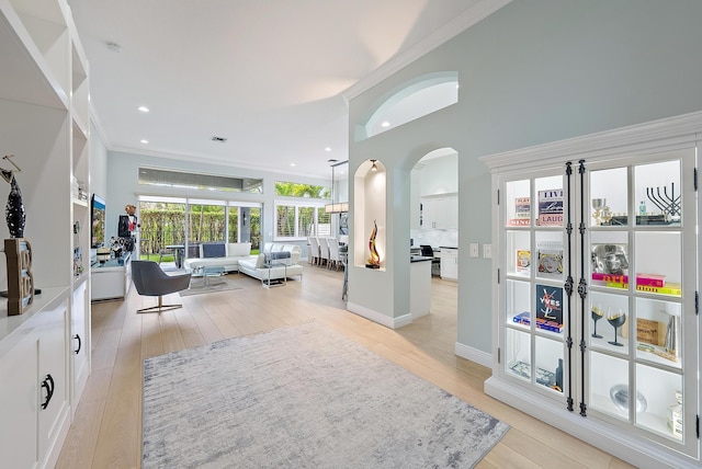 10740 Grande Blvd, West Palm Beach, FL 33412 - interior space featuring crown molding, recessed lighting, arched walkways, light wood-style floors, and a high ceiling