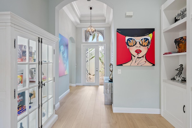 10740 Grande Blvd, West Palm Beach, FL 33412 - foyer featuring arched walkways, french doors, light wood-style floors, and crown molding