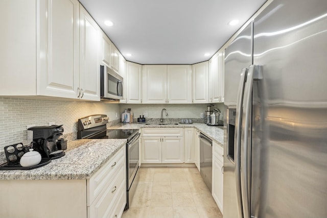 2773 S Ocean Blvd Unit 407, Palm Beach, FL 33480 - kitchen with stainless steel appliances, tasteful backsplash, white cabinets, light stone countertops, and recessed lighting