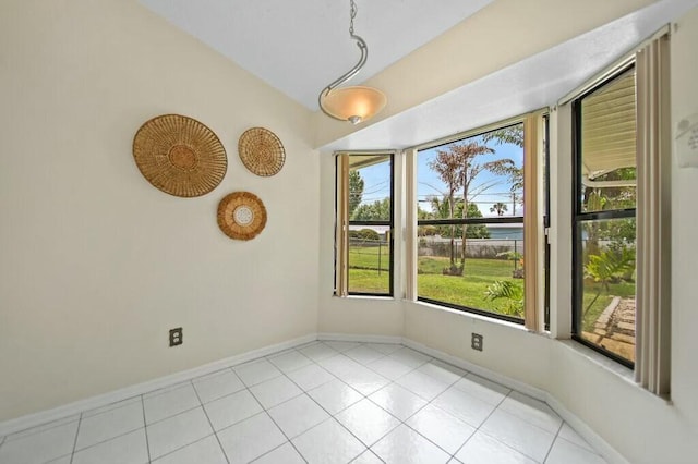 870 SW Gardens Blvd, Palm City, FL 34990 - empty room with baseboards, light tile patterned flooring, and lofted ceiling