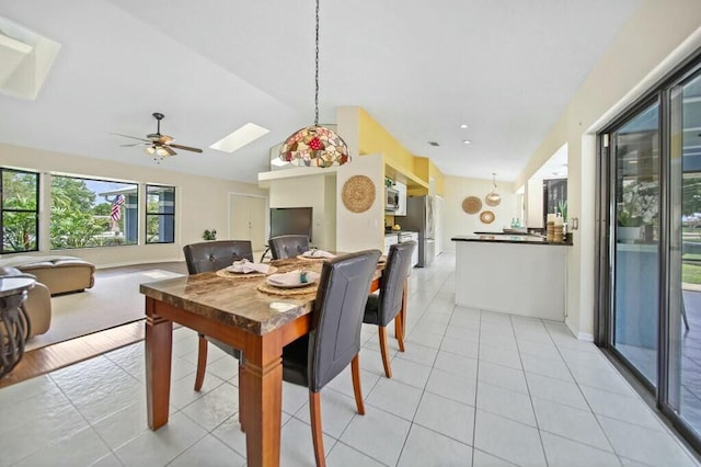 870 SW Gardens Blvd, Palm City, FL 34990 - dining space featuring a ceiling fan, lofted ceiling with skylight, and light tile patterned floors