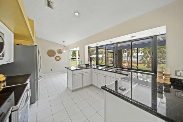870 SW Gardens Blvd, Palm City, FL 34990 - kitchen featuring a sink, electric range, white cabinets, lofted ceiling, and visible vents