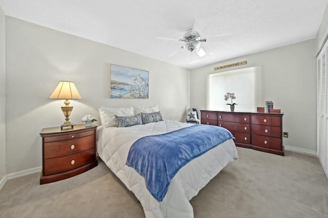 870 SW Gardens Blvd, Palm City, FL 34990 - bedroom with baseboards, a ceiling fan, and light colored carpet