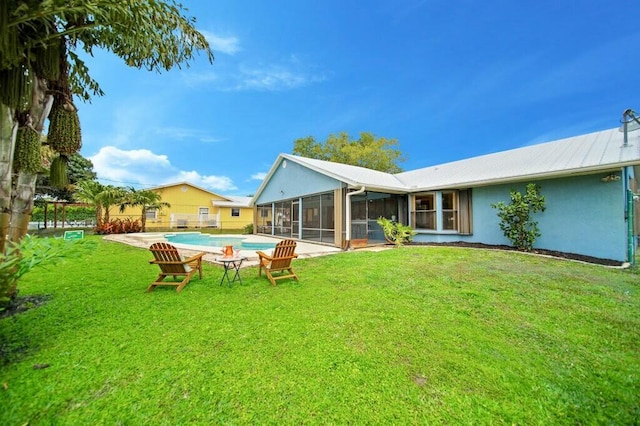 870 SW Gardens Blvd, Palm City, FL 34990 - back of house featuring an outdoor pool, a sunroom, a yard, and stucco siding