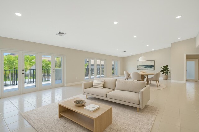living room featuring baseboards, visible vents, and light tile patterned floors