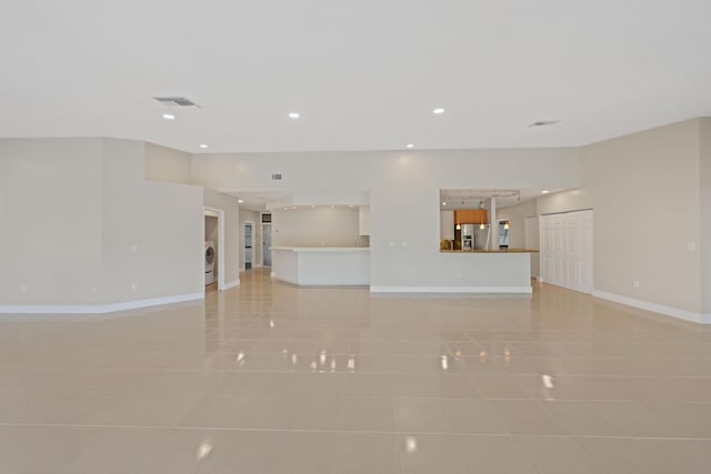 unfurnished living room with light tile patterned floors, baseboards, recessed lighting, and visible vents