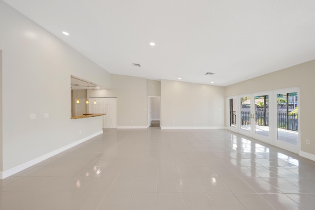 unfurnished living room featuring baseboards, recessed lighting, tile patterned flooring, and visible vents