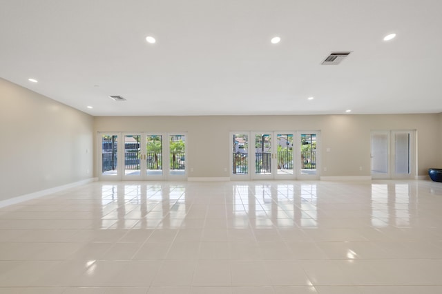 unfurnished room featuring light tile patterned floors, baseboards, recessed lighting, and visible vents