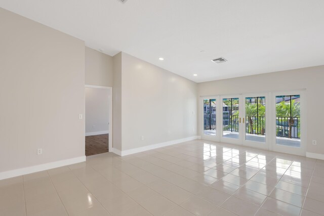 empty room with french doors, visible vents, baseboards, recessed lighting, and light tile patterned flooring
