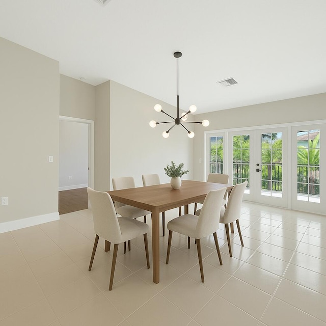 dining room featuring french doors, light tile patterned floors, a notable chandelier, and visible vents