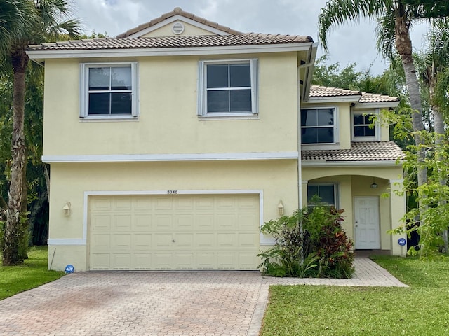 5340 NW 51st St, Coconut Creek, FL 33073 - view of front of home featuring a tiled roof, stucco siding, and a garage