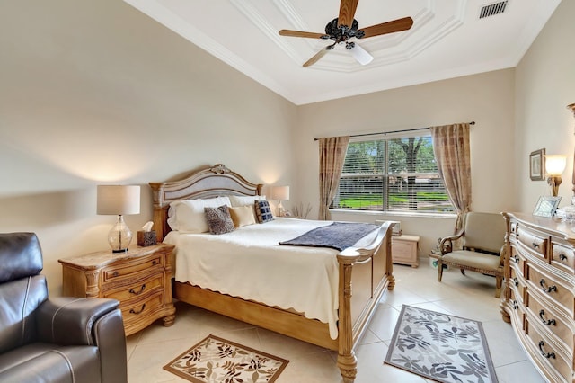 bedroom with light tile patterned floors, ceiling fan, a tray ceiling, ornamental molding, and visible vents