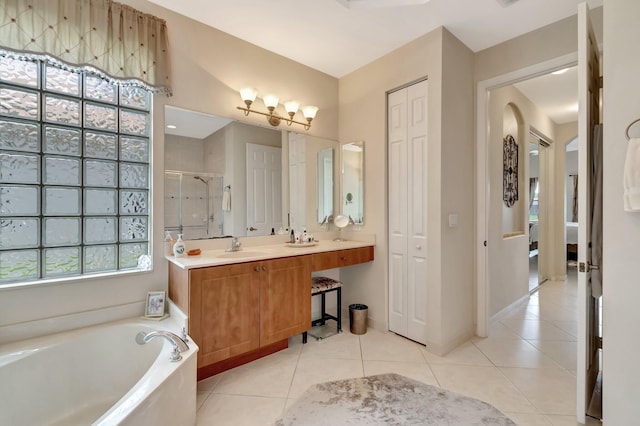 bathroom with a garden tub, vanity, tile patterned floors, and a stall shower