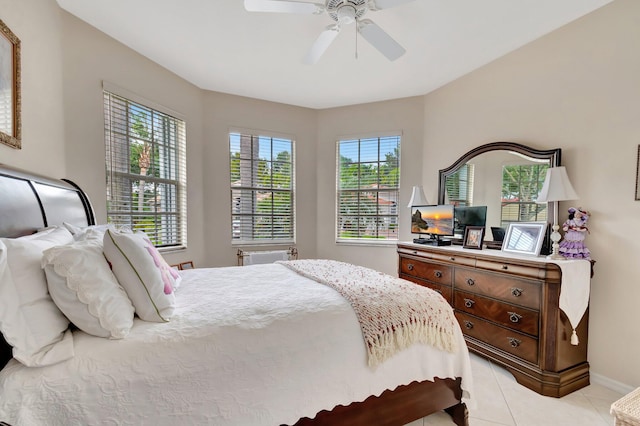 bedroom featuring ceiling fan, baseboards, and light tile patterned floors