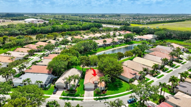 bird's eye view featuring a water view and a residential view