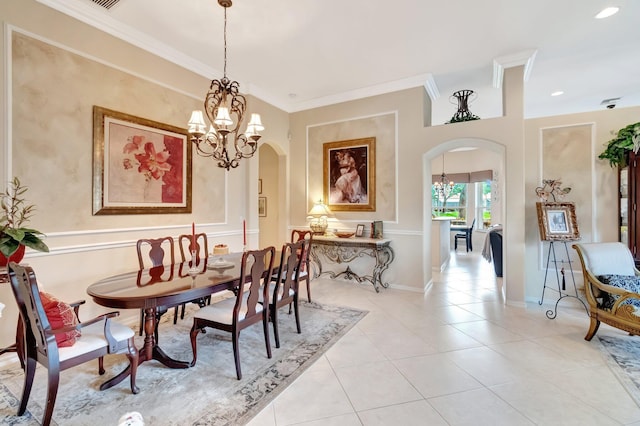 dining space featuring crown molding, arched walkways, a notable chandelier, and light tile patterned flooring