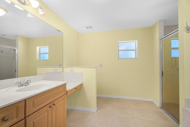 full bath featuring tile patterned flooring, vanity, baseboards, a stall shower, and visible vents