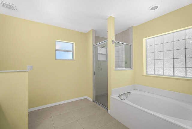 full bathroom featuring a bath, baseboards, tile patterned floors, and a shower stall