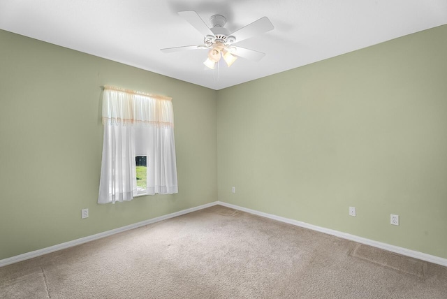 unfurnished room featuring baseboards, carpet flooring, and a ceiling fan