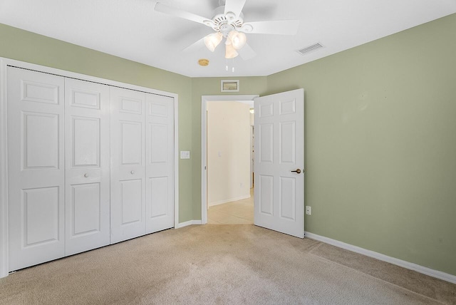 unfurnished bedroom featuring light carpet, baseboards, a closet, and visible vents