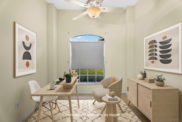 office space with baseboards, a wealth of natural light, and a ceiling fan