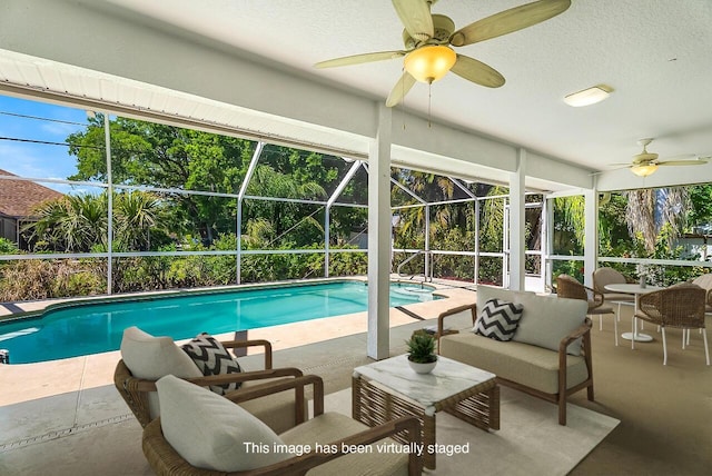 outdoor pool with outdoor lounge area, ceiling fan, a lanai, and a patio area