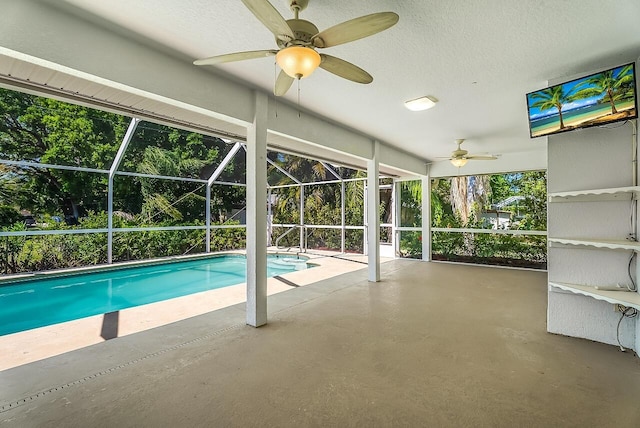 pool with a ceiling fan, a lanai, and a patio area