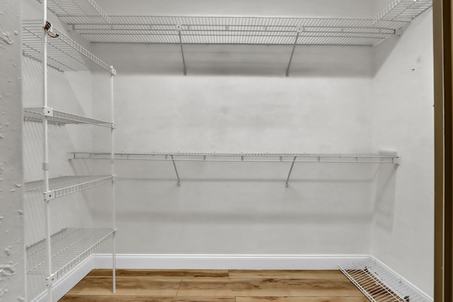 walk in closet featuring visible vents and wood finished floors