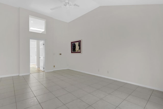 empty room featuring baseboards, high vaulted ceiling, ceiling fan, and light tile patterned floors