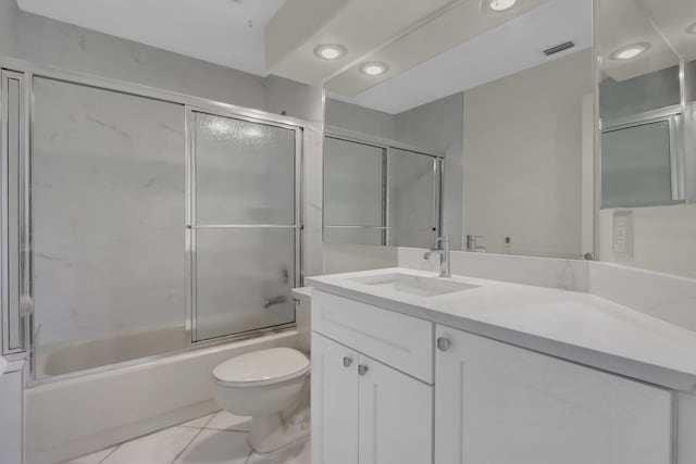 full bath featuring tile patterned flooring, vanity, toilet, visible vents, and combined bath / shower with glass door