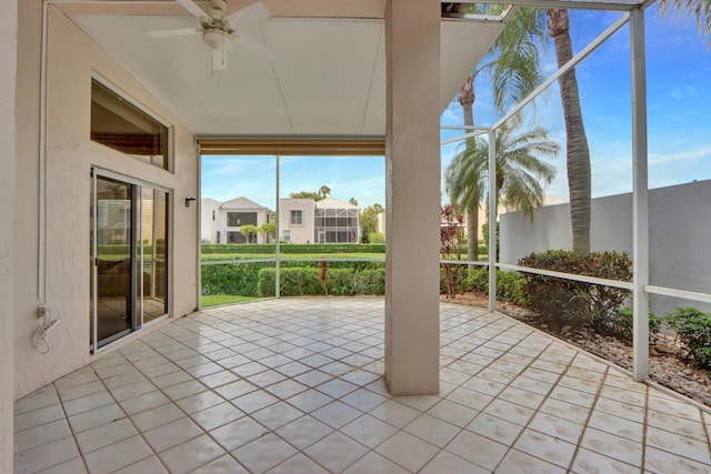 unfurnished sunroom featuring a ceiling fan