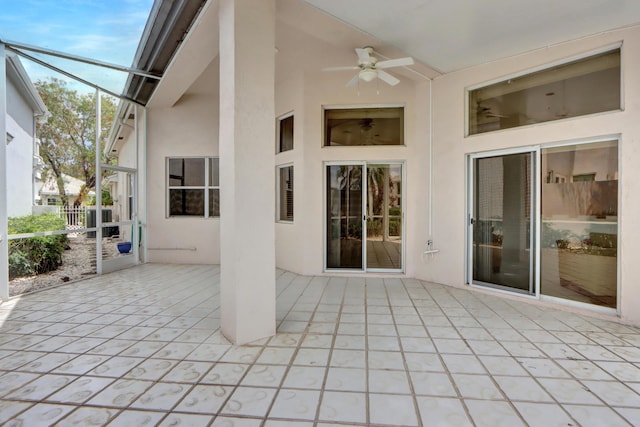 view of patio / terrace with a ceiling fan and a lanai