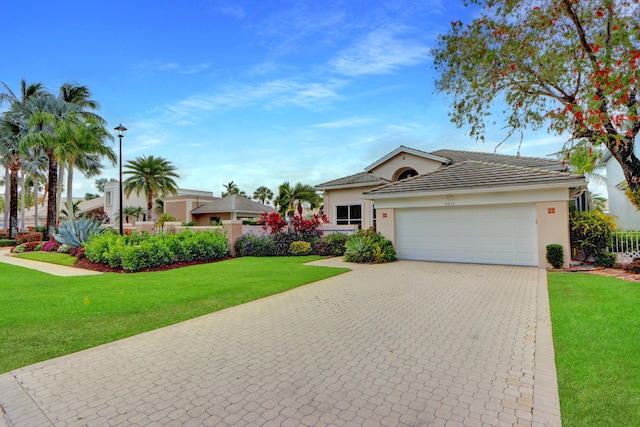single story home featuring a garage, decorative driveway, stucco siding, and a front lawn