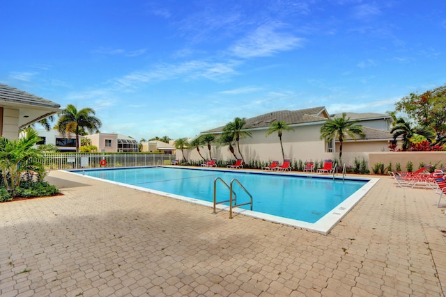 pool with fence and a patio