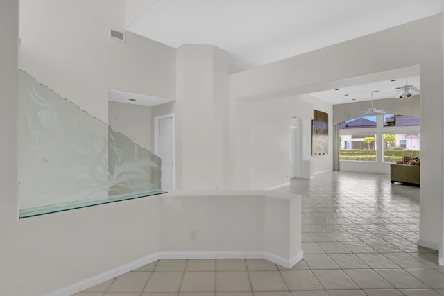 unfurnished room featuring light tile patterned flooring, baseboards, visible vents, and ceiling fan