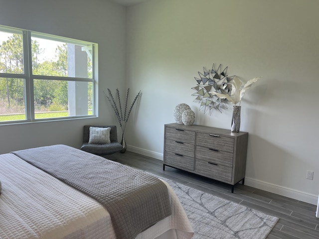 130 SE Palma St, Port Saint Lucie, FL 34984 - bedroom featuring baseboards and wood finish floors
