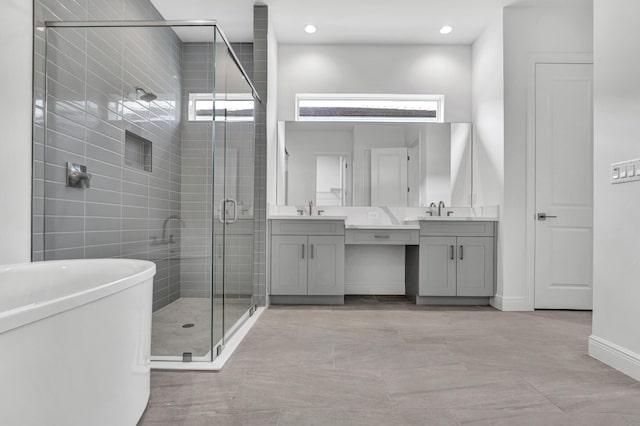 130 SE Palma St, Port Saint Lucie, FL 34984 - full bathroom featuring vanity, a shower stall, a soaking tub, baseboards, and recessed lighting
