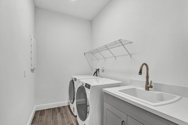 130 SE Palma St, Port Saint Lucie, FL 34984 - washroom featuring washer and dryer, dark wood finished floors, baseboards, and cabinet space