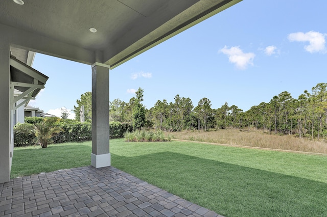 130 SE Palma St, Port Saint Lucie, FL 34984 - view of green lawn featuring a patio area