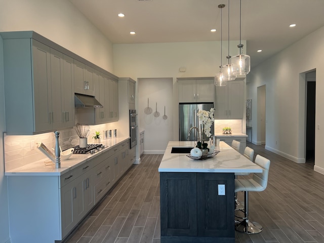 130 SE Palma St, Port Saint Lucie, FL 34984 - kitchen with appliances with stainless steel finishes, under cabinet range hood, recessed lighting, baseboards, and dark wood-style floors