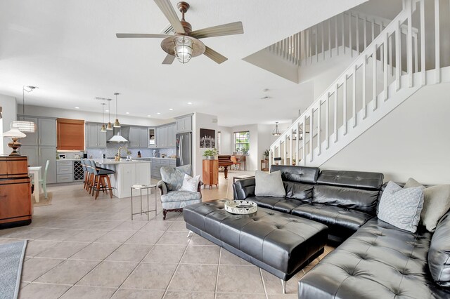 living area featuring light tile patterned floors, recessed lighting, stairs, and ceiling fan