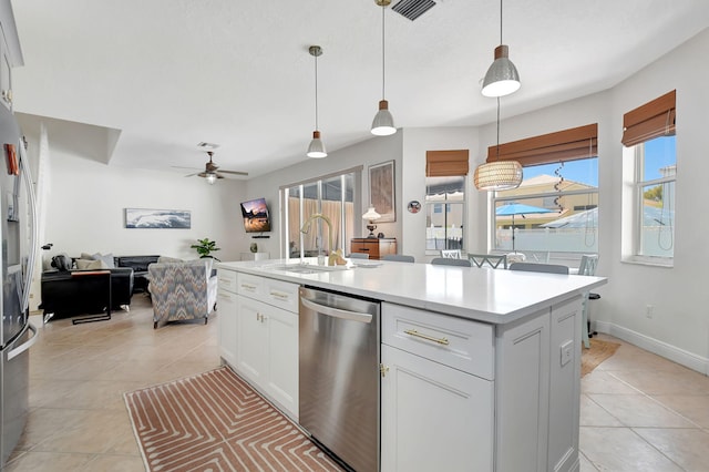 kitchen with light countertops, a sink, visible vents, and stainless steel dishwasher