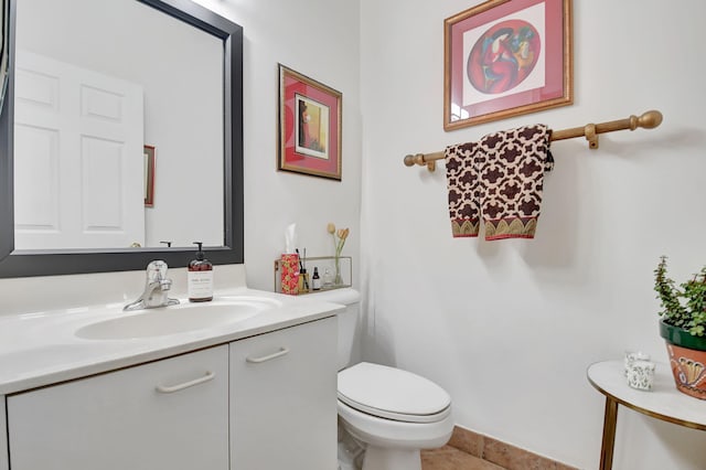 half bath featuring toilet and vanity