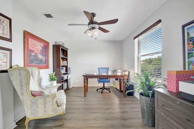 office area featuring baseboards, visible vents, a ceiling fan, and wood finished floors